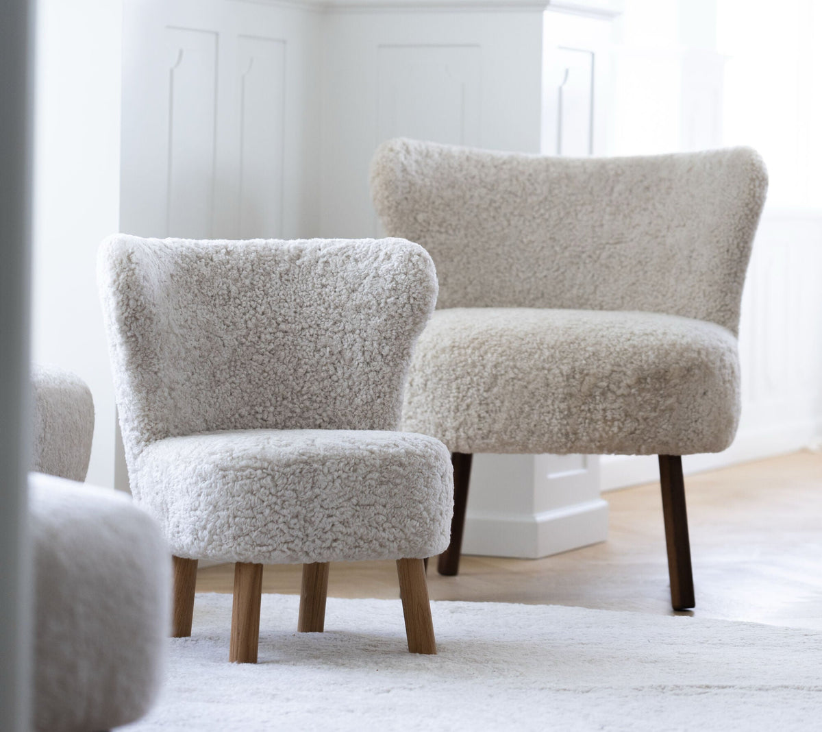 Two shearling lounge chairs