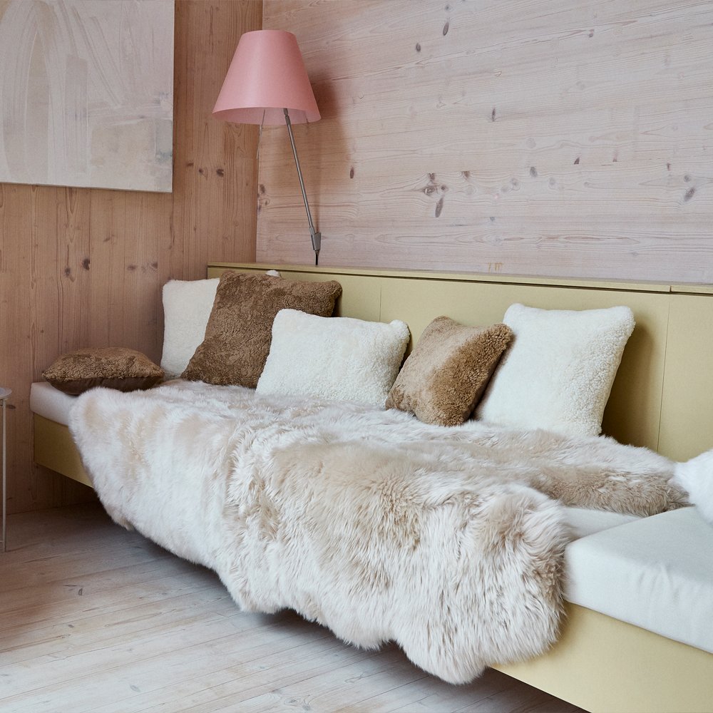 Daybed with sheepskin rugs and cushions