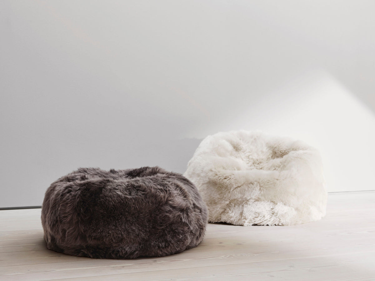 Two round sheepskin bean bags in brown and cream