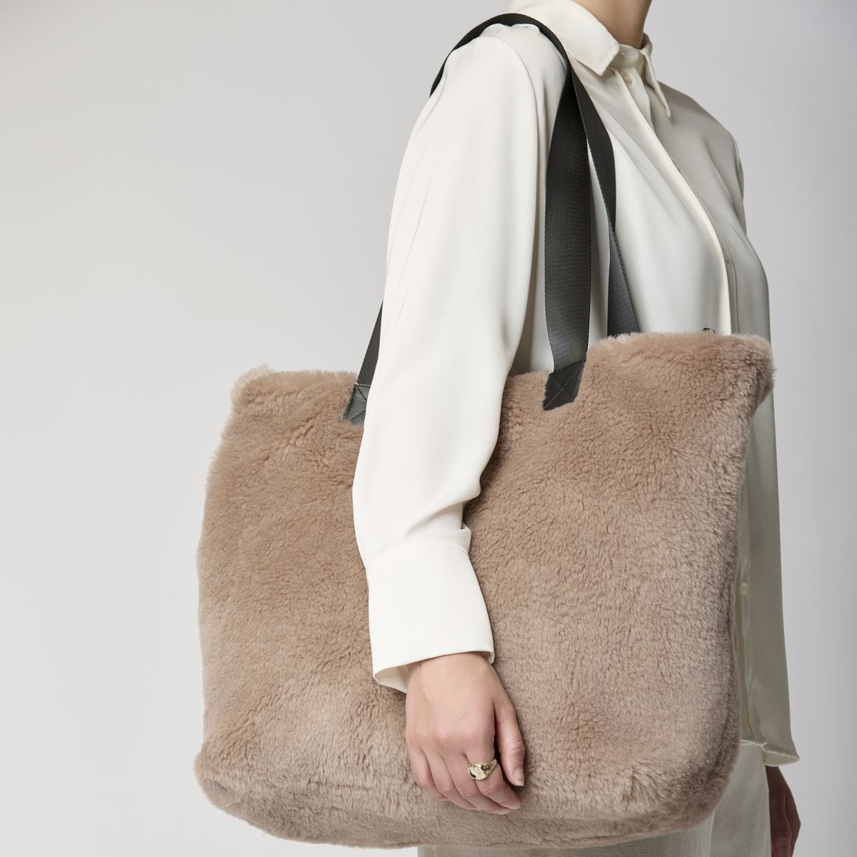 Woman carrying a soft plush tote bag