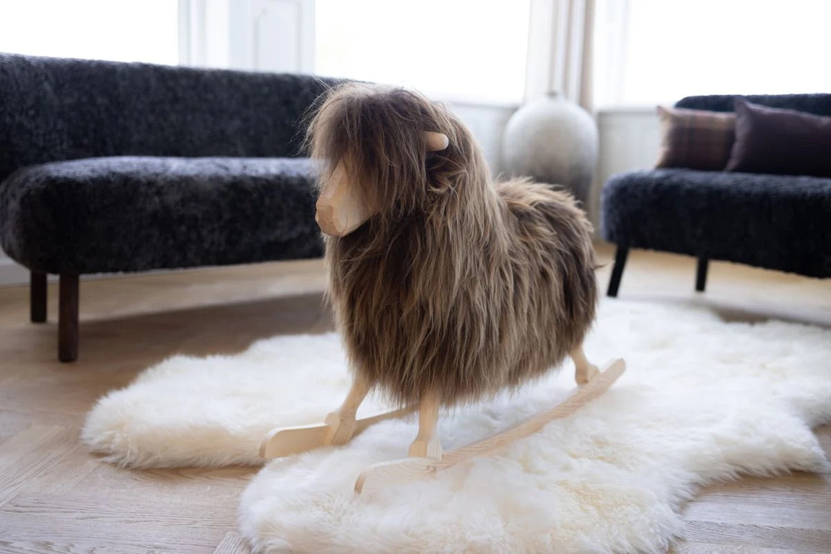 Rocking sheep on a white sheepskin rug