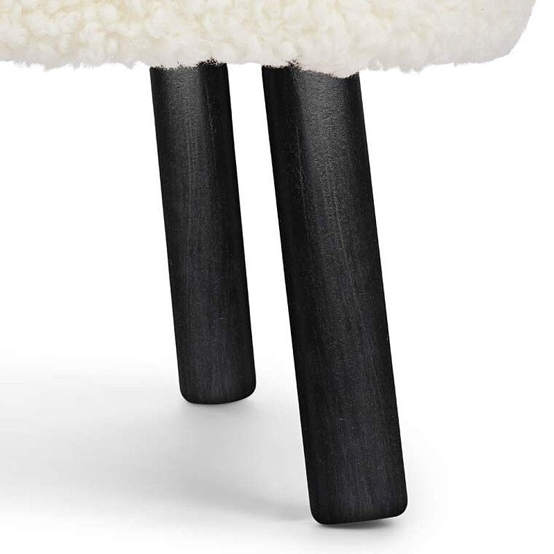 Detail of two black beech legs under an ivory short hair seat