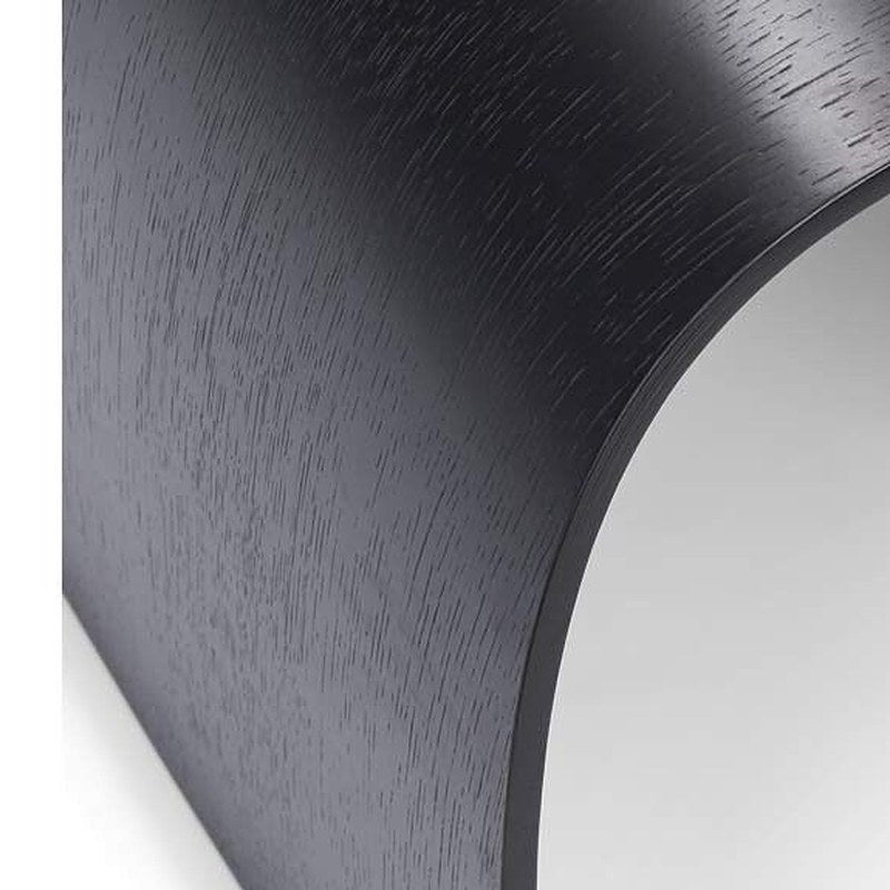 Curved black oak base of the Sheep stool with the oak grain showing through