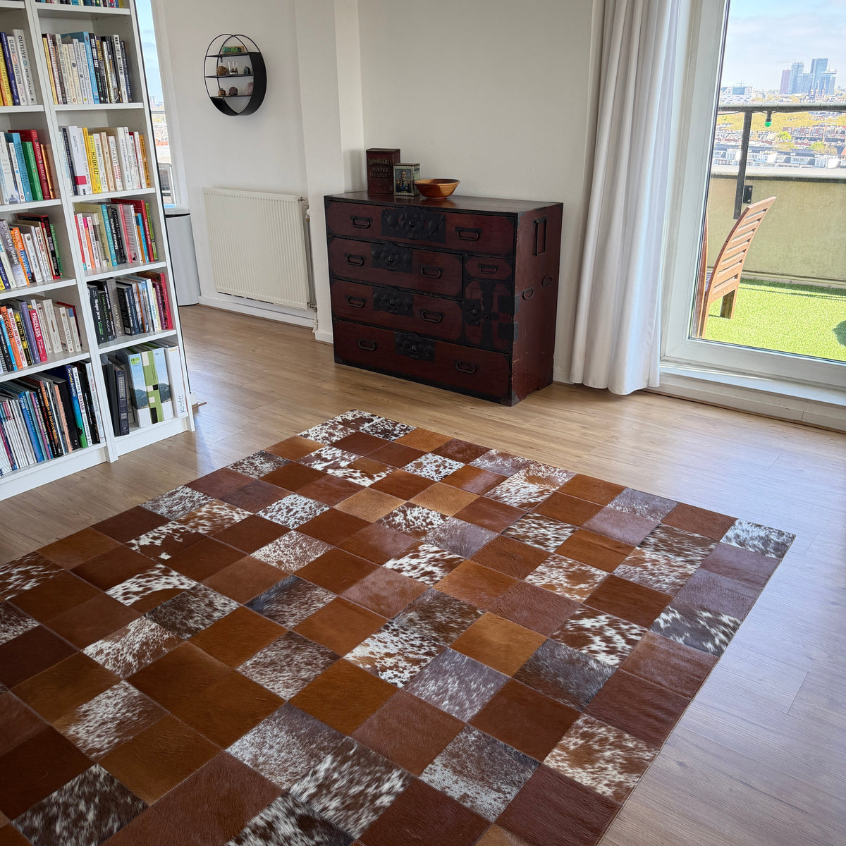 Lisbon cowhide patchwork rug in brown and white in a living room