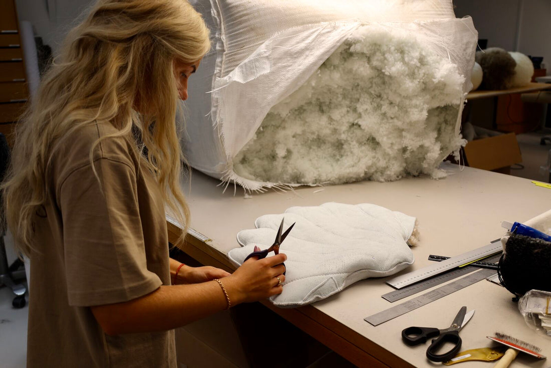 Cutting a sheepskin for a cushion in the sewing room in Denmark